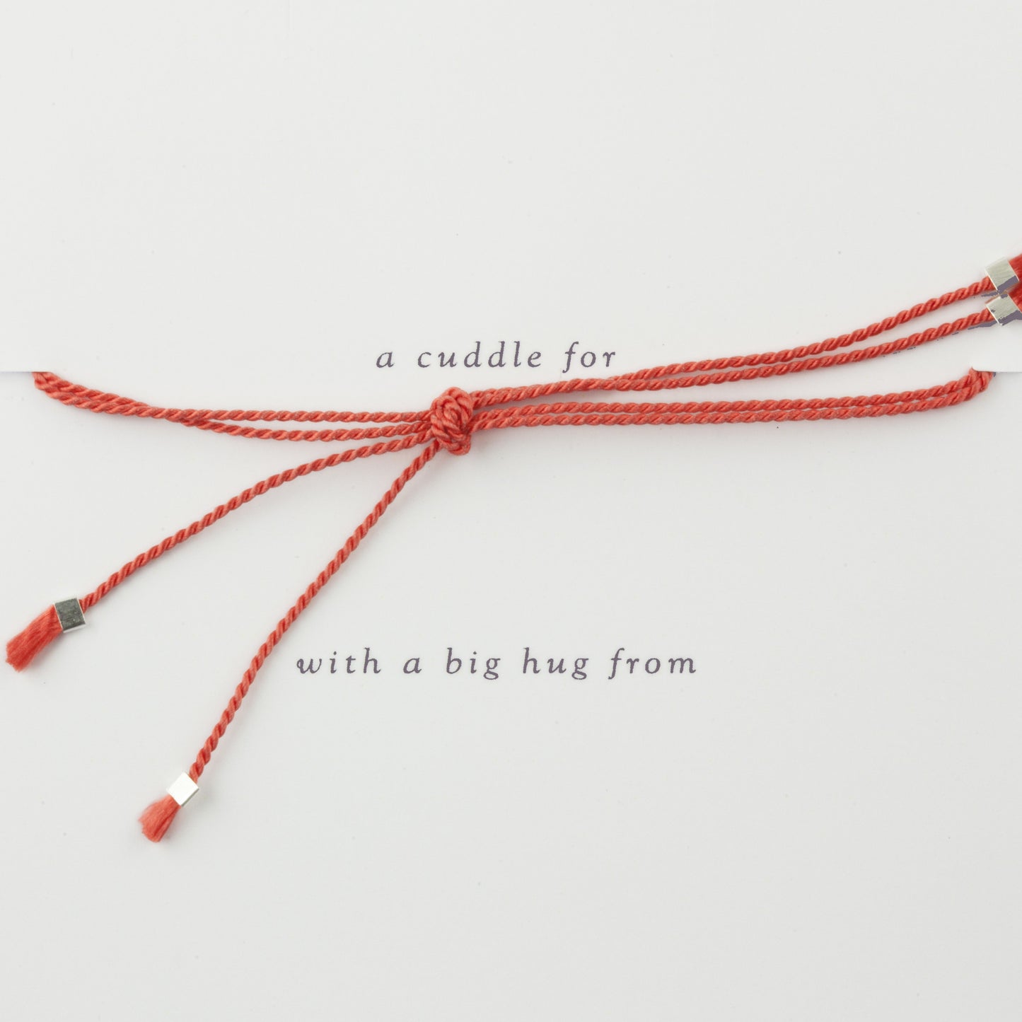 Cuddle charm bracelet on red silk thread